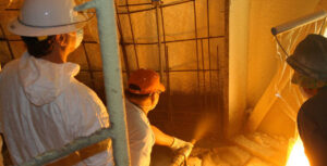 Spraying Shotcrete on the inside of the airform along with the spray foam insulation.