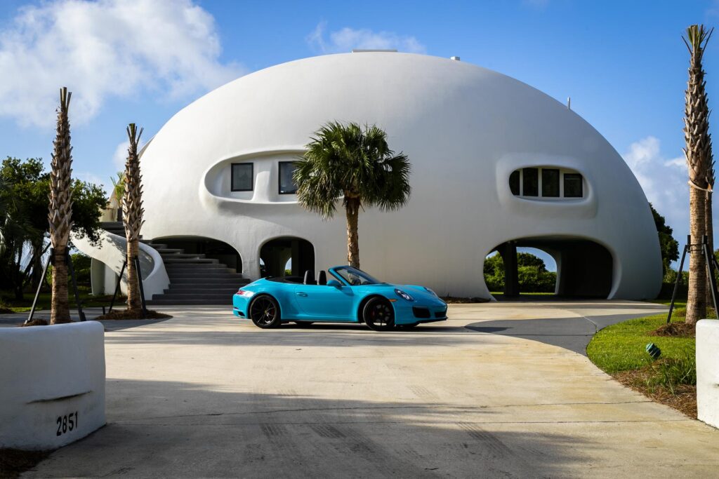 One of the most iconic dome homes today, the Eye of the Storm combines strength and security with stunning modern design to create a dome home that matches that hot electric-blue convertible Porsche that's sitting in its driveway.
