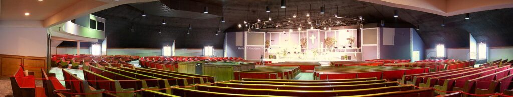 The wide-open interior of Hillside Church's massive concrete dome church sanctuary. With no support structures needed, the sanctuary can comfortably fit 4,000 people and still have room for a large stage and baptismal font.