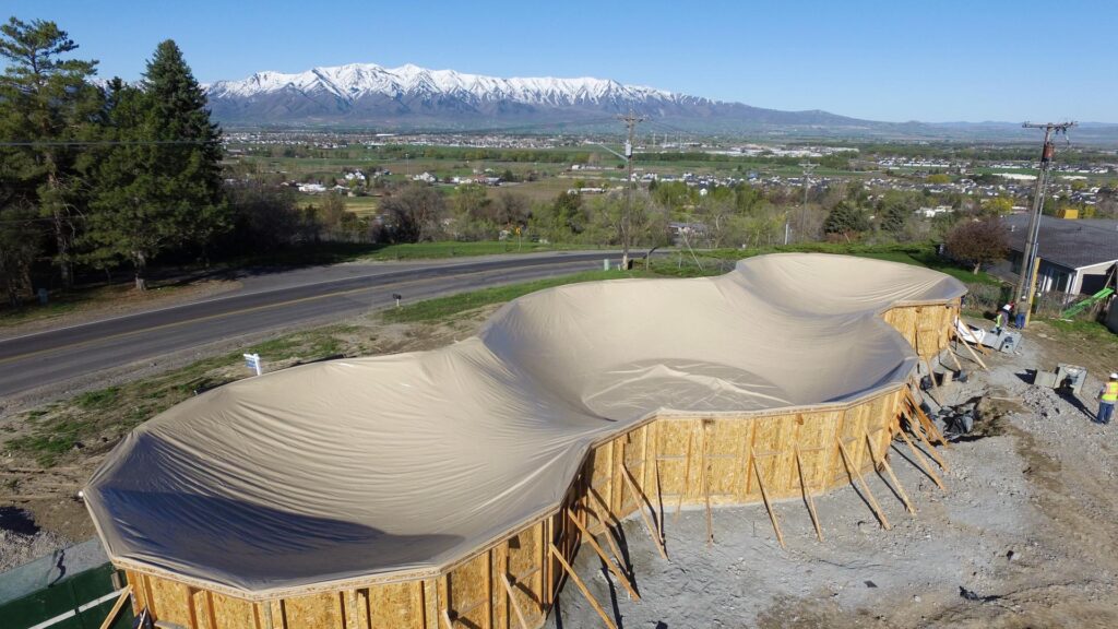 The Arcadia Home: The PVC airform is attached on top of the poured stem walls, waiting for inflation before the next steps begin.