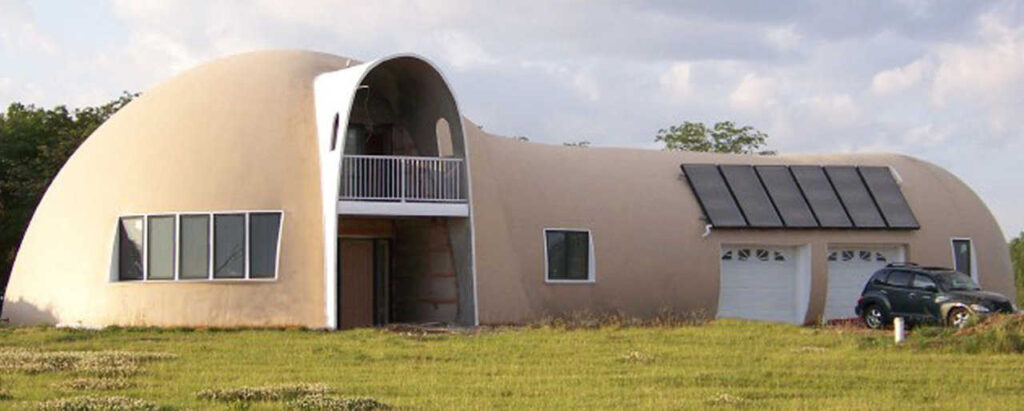 This dome home includes a torus-inspired extension for the garage and solar panels.